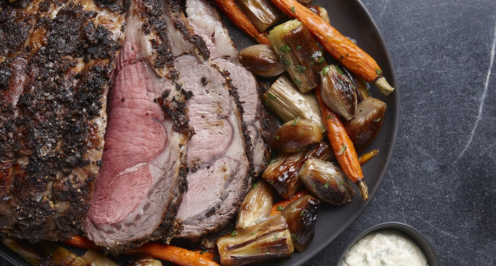 Mustard and salt-crusted rib roast with roasted vegetables and horseradish-mustard cream